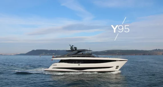 "Princess-y95" Luxury yacht Princess Y95 cruising on a calm sea with a coastline in the background and clear blue skies above.